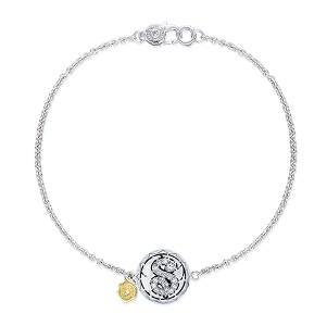 A medallion chain bracelet with a diamond studded ‘S’ initial