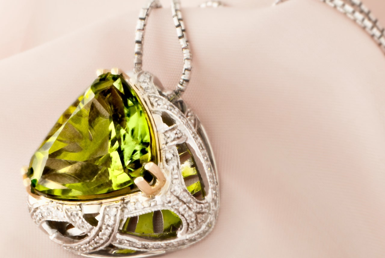 A silver pendant that features peridot celebrates an August-born beauty