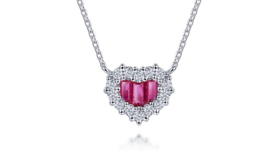 A heart-shaped pendant necklace with pink gemstones at its center