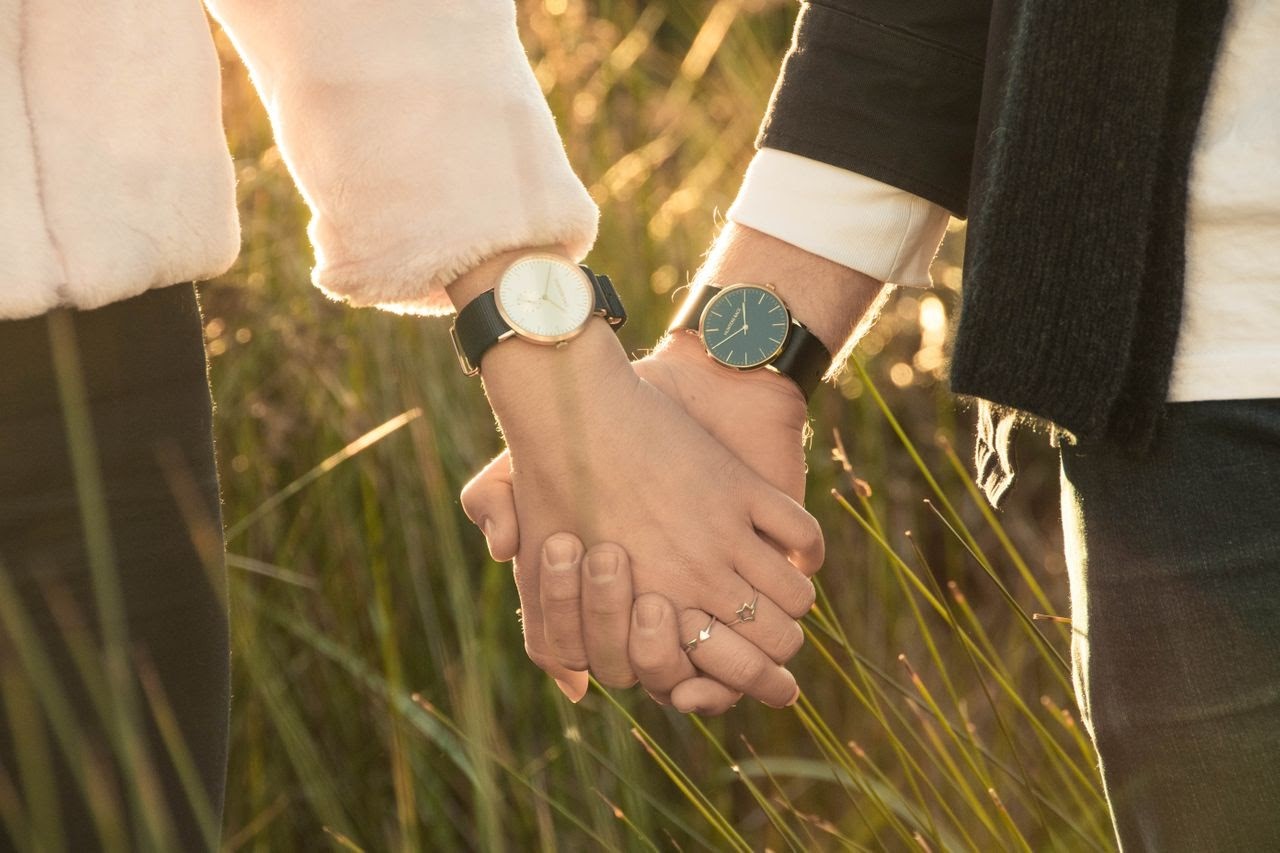 couple with watches holding hands