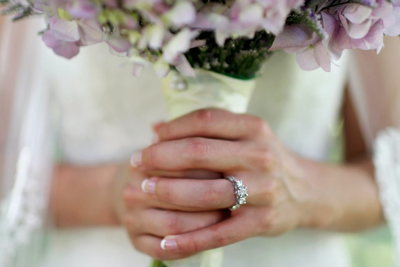 a lady’s hands wearing a bouquet of flowers