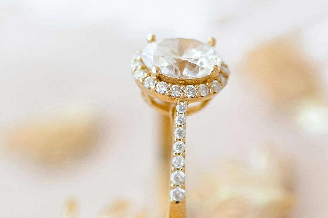 a yellow gold and diamond halo engagement ring