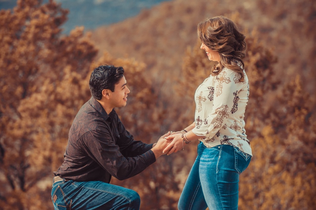 a man on one knee proposing to a woman